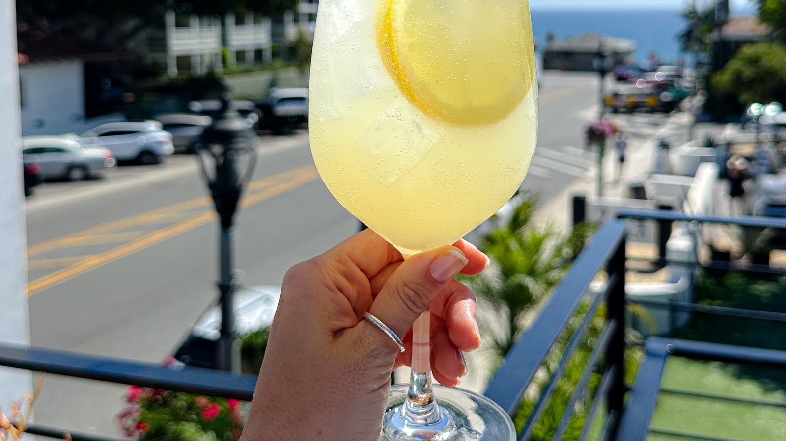 A cocktail at 264 Fresco, ocean and palms beyond