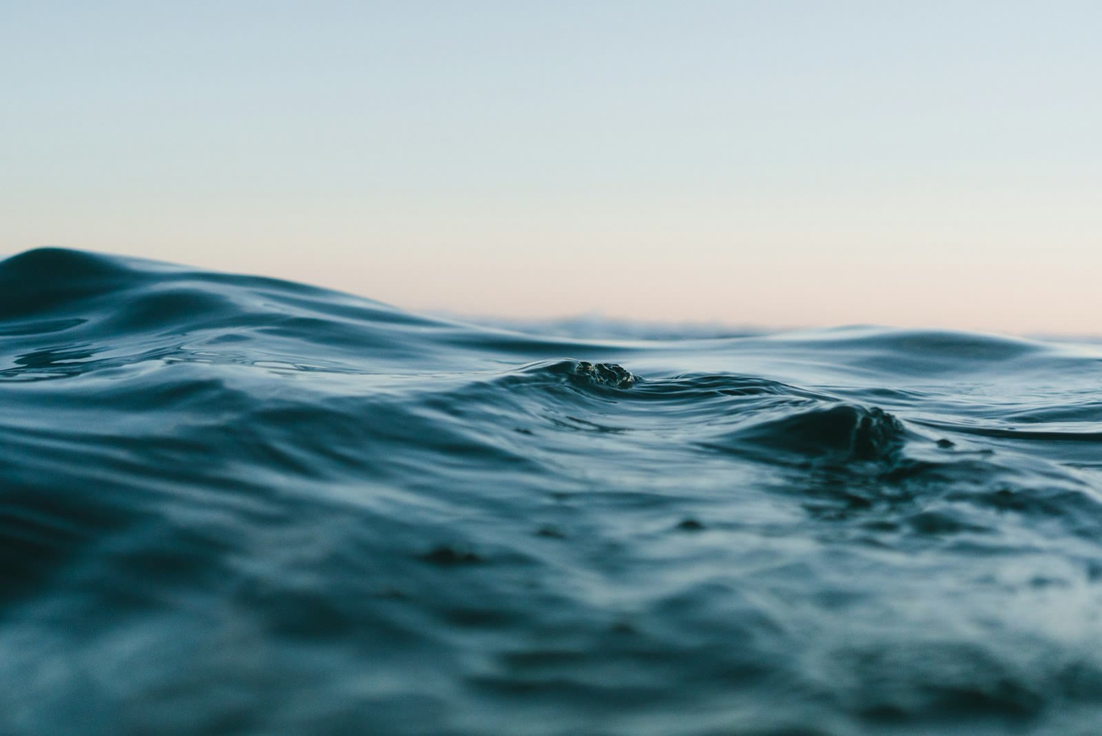Close soft ocean waves under a quiet morning sky