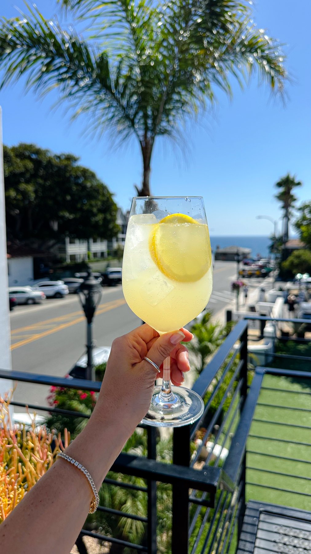 Cocktail on The Deck at 264 Fresco, ocean and palms beyond