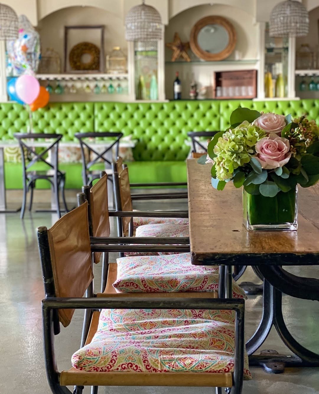 The Green Room at 264 Fresco — tufted banquettes and a table of flowers