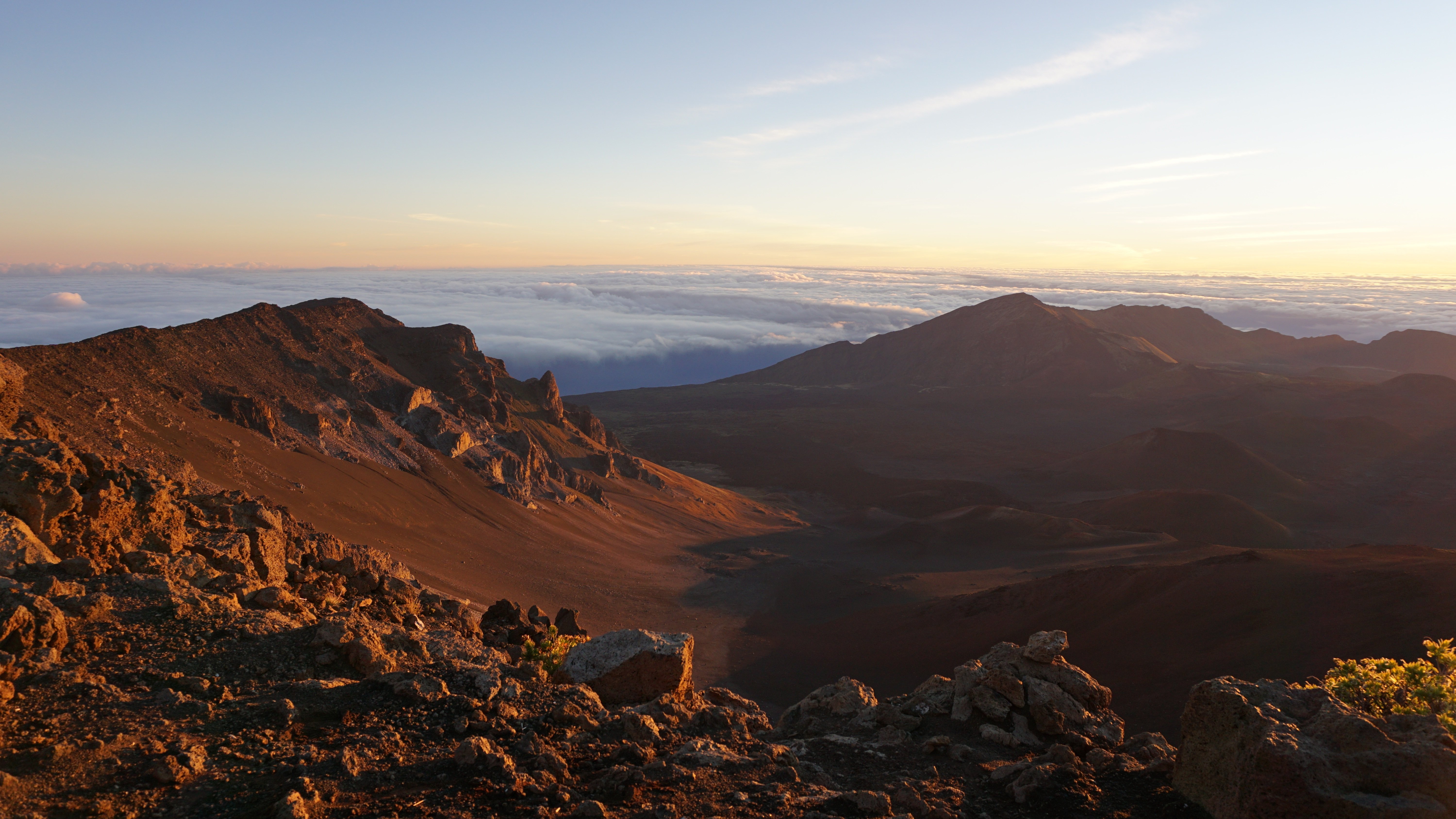 Haleakalā volcano at sunrise — sea of clouds and warm dawn glow