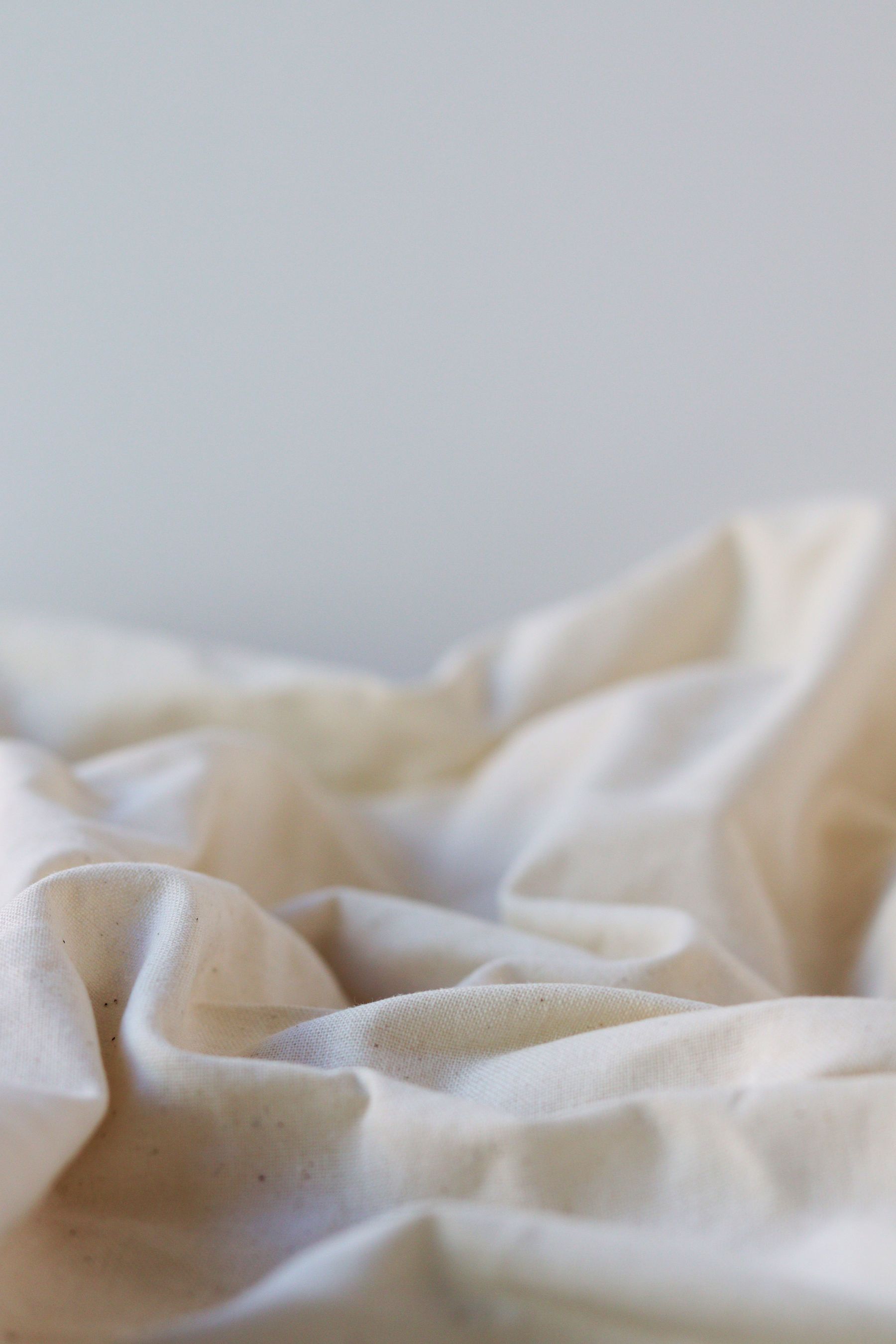 Soft folds of white linen in quiet light