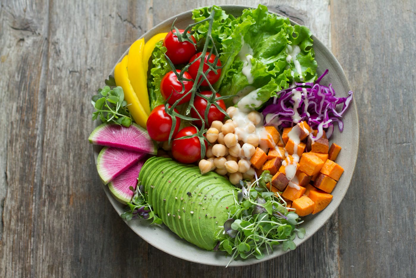 Elegant plant-based nourishment bowl with avocado, greens, and roasted vegetables